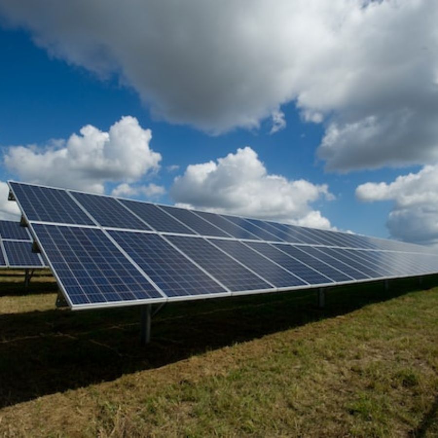 a cloudy sky over solar panels on a field