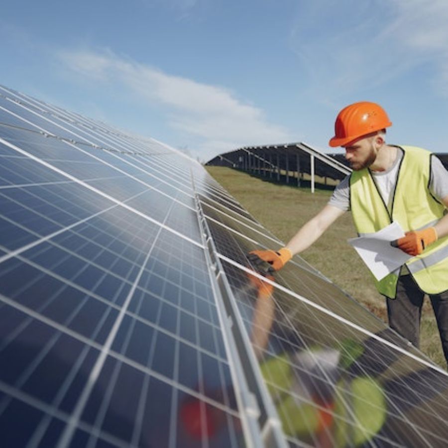 A man inspecting solar panels for damages