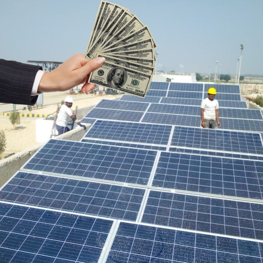a hand holding money against a solar panels project