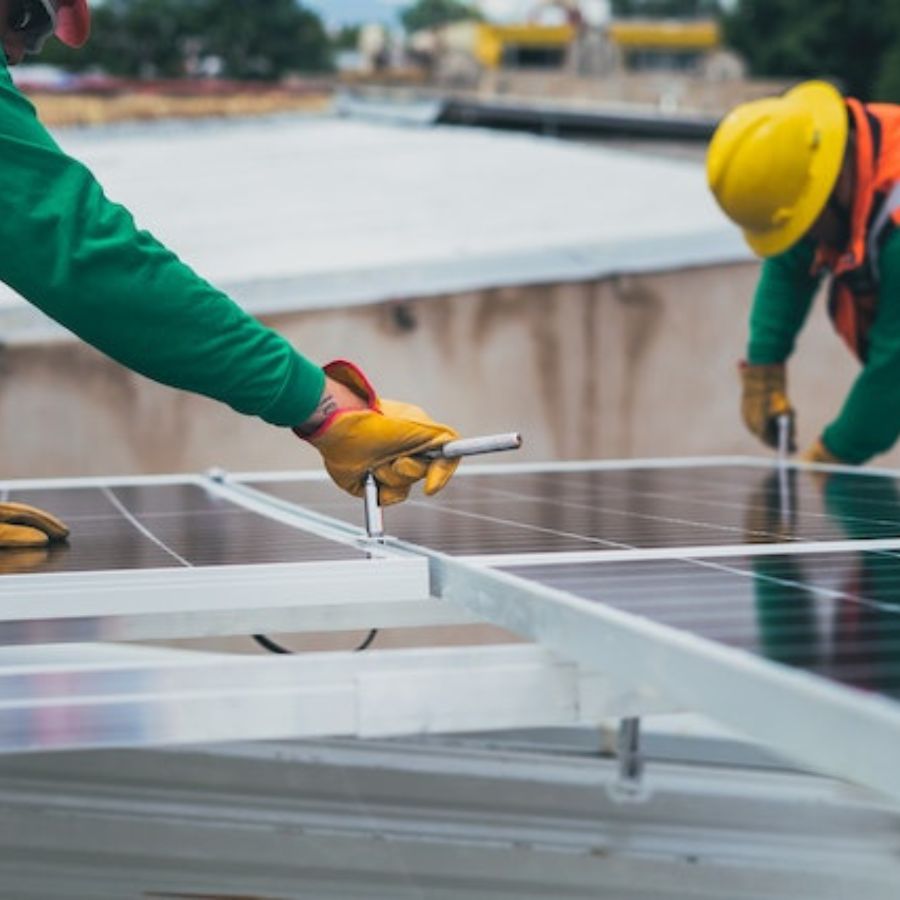 workers fixing solar panels