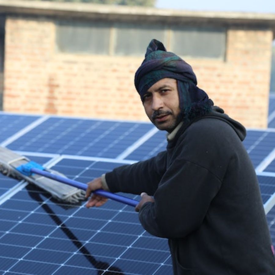 a man cleaning solar panels